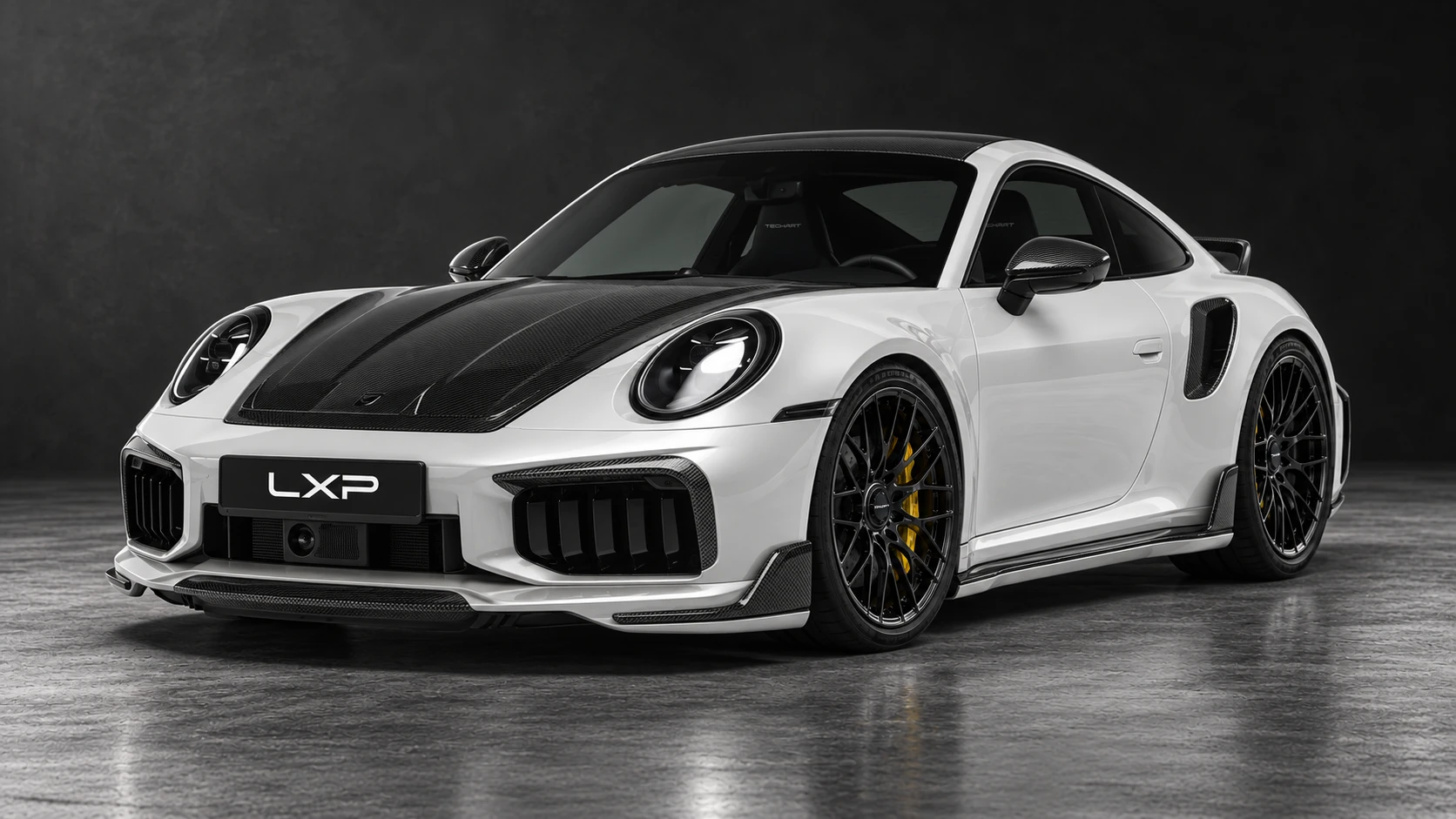 Pearl-white Porsche 911 Turbo S 992.2 with TECHART carbon aero and black Formula IX wheels: Low front three-quarter