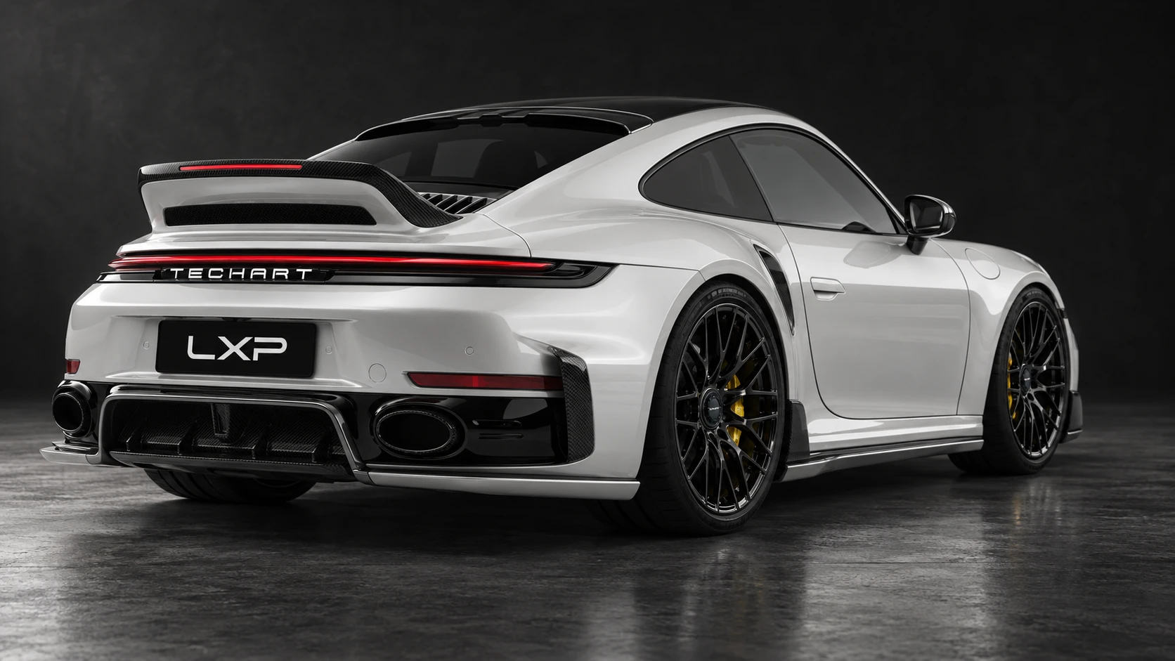Pearl-white Porsche 911 Turbo S 992.2 with TECHART carbon aero and black Formula IX wheels: Low rear three-quarter