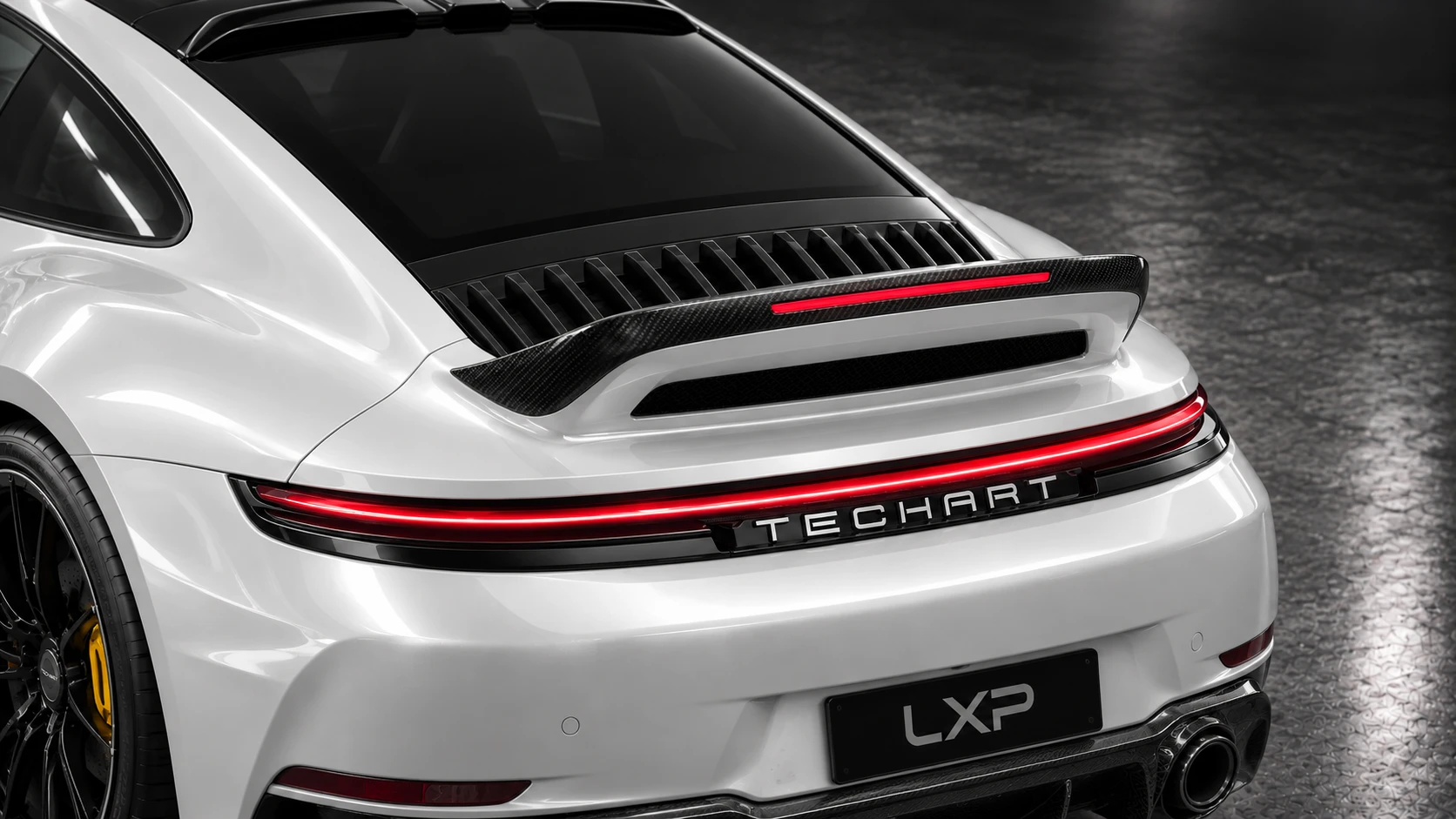 Pearl-white Porsche 911 Turbo S 992.2 with TECHART carbon aero and black Formula IX wheels: Upper rear detail